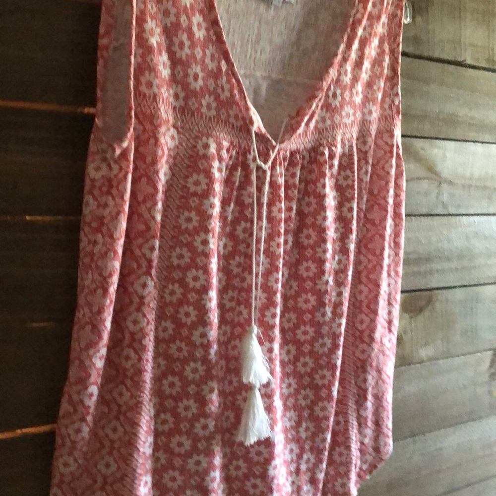 Sleeveless salmon and white colored top